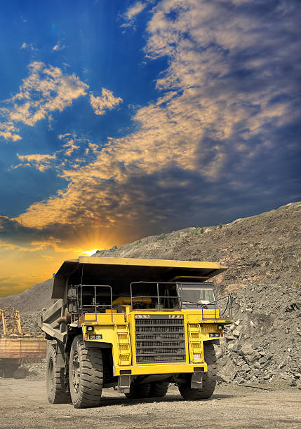 Heavy dump truck transporting iron ore from the opencast on sunset Heavy dump truck transporting iron ore from the opencast on sunset