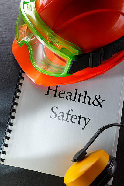 Safety goggles, earphones and red helmet Safety goggles, earphones and red helmet